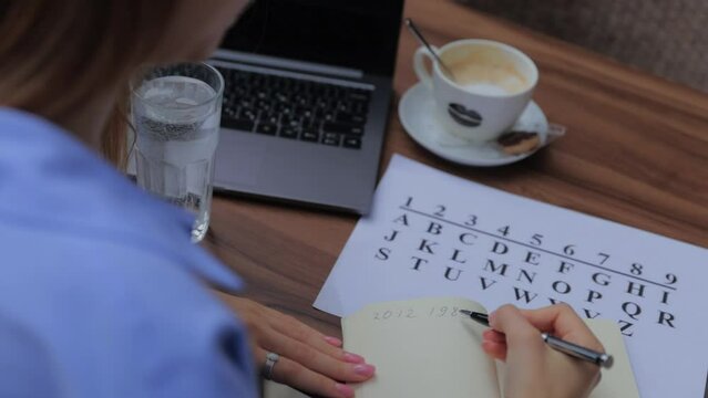 numerologist girl makes a calculation according to numerology, future by date of birth, find out her purpose with the help of numbers top view