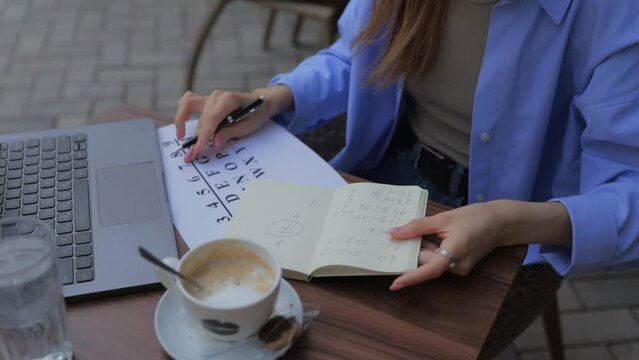 numerologist girl makes a calculation according to numerology, future by date of birth, find out her purpose with the help of numbers top view