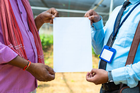 Close Up Shot Of Indian Farmer With Banking Officer Holding Empty White Sign Board At Greenhouse - Concept Of Deal, Agreement And Certification