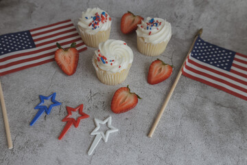 Cupcakes on the beautiful table. Healthy breakfast. Strawberry on cupcakes. American flag. Independence Day 4th of July.