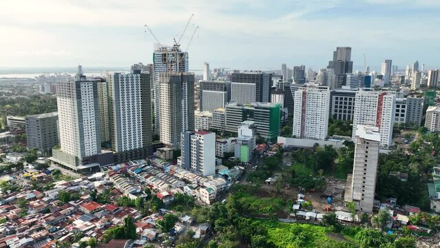 Aerial shot of the poor neighborhoods mixed in with new modern high-rises in Cebu City Philippines.
