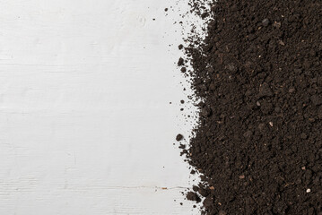Pile dirt, soil on white wood, top view