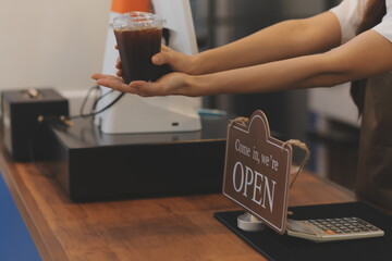 Portrait of a woman, a coffee shop business owner who is smiling beautifully and opening a coffee shop that is her own business, SME concept.