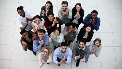 group of happy young business people looking up