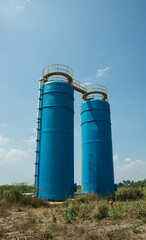 Large concrete reserved water tanks on field.