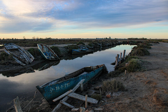 dawn in a cemetery of abandoned boats