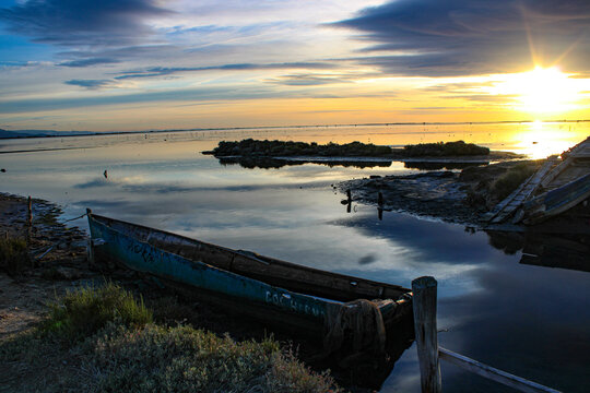 dawn in a cemetery of abandoned boats