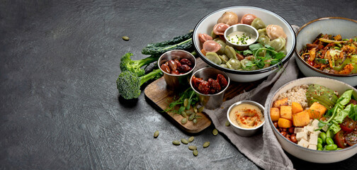 Fototapeta na wymiar Vegetarian and various vegan dishes on dark table.