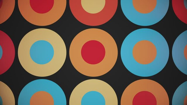 Trendy retro 1970s geometric background with colorful blinking circles in warm color tones - beige, orange, red and blue. This stylish vintage motion background animation is 4K and a seamless loop.