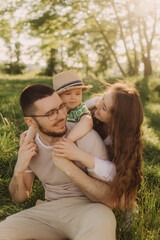Summer day for a young family, dad, mom and little son became joyful and happy. Happy family...
