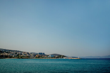 A view of a populated Turkish city on the seashore. Mountain horizon of the seashore