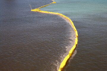 Pollution control barrier in the sea viewed from the city pier Anna maria island florida united...