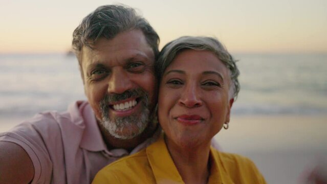 Senior couple, beach selfie and funny at sunset for romance or profile picture for blog. Face of man, woman and photography by ocean for love, peace sign and social media app on retirement holiday