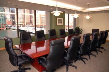 Black chairs at a boardroom table.