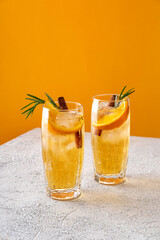 Fresh cocktail with orange, ice and herbs on the  table. Refreshing drink on a hot summer day. Ice...