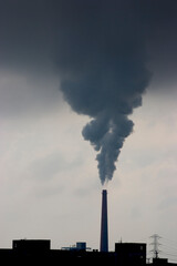 A smokestack belches pollution from a power plant.