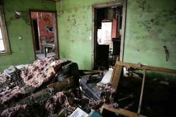 My Living room after hurricane Katrina.  Furniture is tossed about and then covered with fallen...