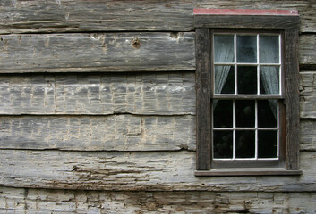 A very rustic window on an old mountain cabin.