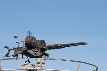 A large caliber machine-gun on the deck of a submarine.