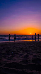 Fototapeta premium People on the beach at sunset