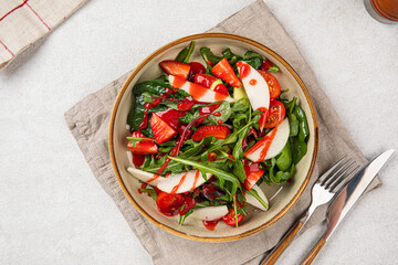 Portion of healthy colorful salad with strawberry and greens