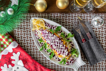 Layered salad herring under fur coat on table. Portion of traditional russian salad with herring,...