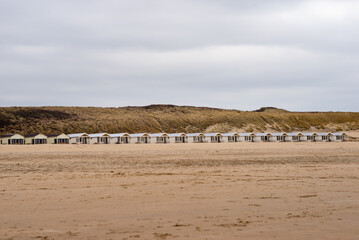 Row of rental wooden houses on the sandy Katwijk beach, Netherlands