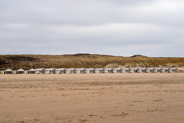 Row of rental wooden houses on the sandy Katwijk beach, Netherlands