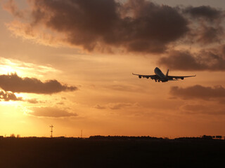 Fototapeta na wymiar Cloudy Sunrise take-off for a tropical destination.