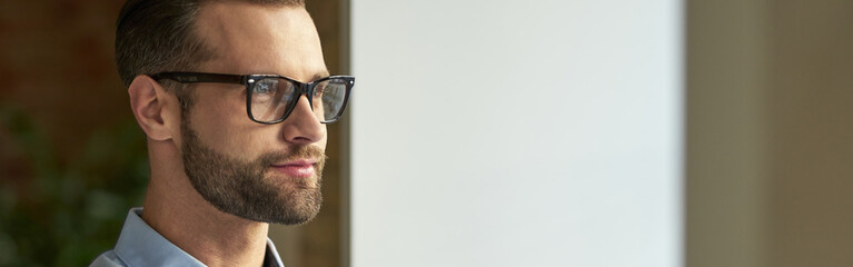 Portrait of attractive Caucasian businessman looking away
