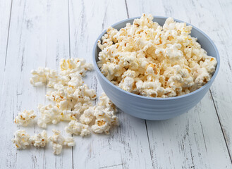 Popcorns on a bowl over wooden table