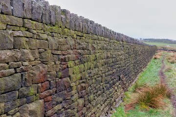 Fototapeta na wymiar old stone wall in field