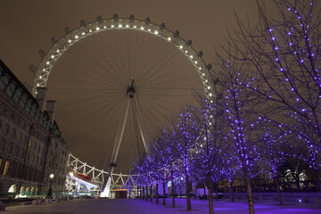 Christmas decorations in the trees with the London Eye in the background