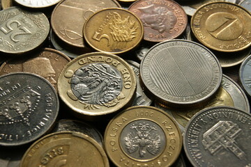 A fragment of a coin pile. Coins of different countries. Background. - obrazy, fototapety, plakaty