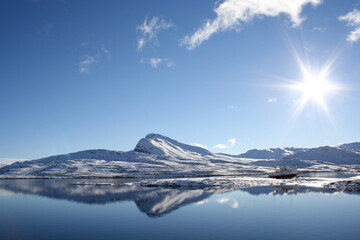 The mountain Bitihorn reflecting in the lake Bygdin in Valdres, Norway.