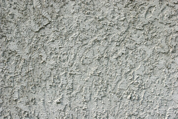 Closeup of gray stucco wall.