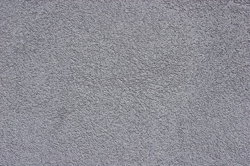 Closeup of gray stucco wall.