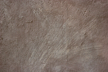 Closeup of brown stucco wall.