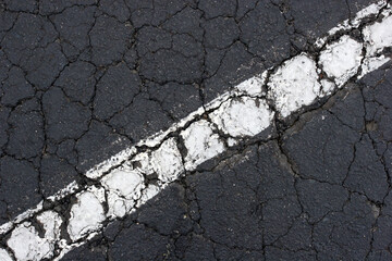 White line on black asphalt.