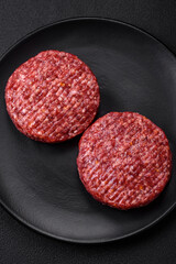 Fresh raw ground beef burger patty with salt and spices