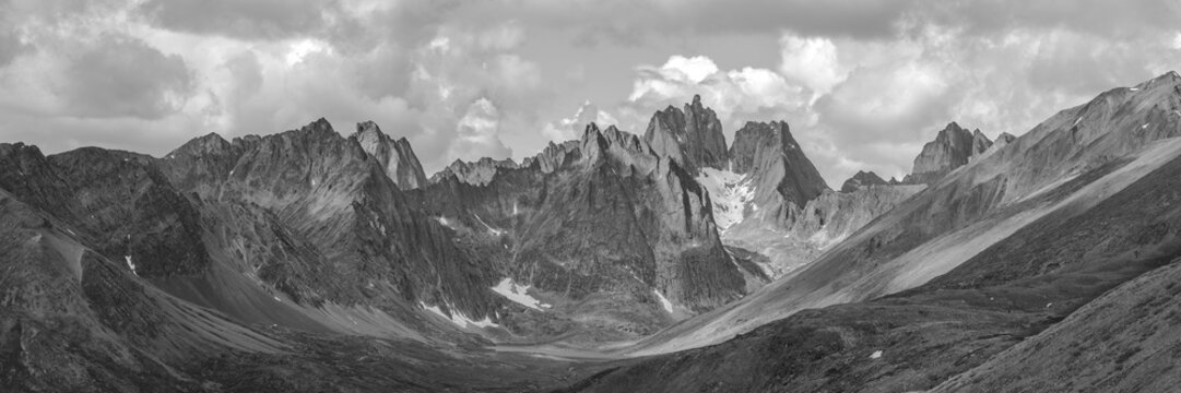 Greyscale, grayscale, black white mountains scene  fall, autumn in northern Canada, Yukon Territory. Tombstone Territorial Park, Grizzly Lake clouds, moody, depressing, dark panoramic, panorama