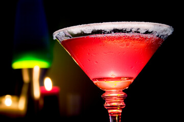 Watermelon martini (could be cherry or strawberry) drink with sugar coating around the rim and a...