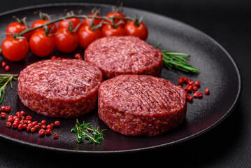 Fresh raw ground beef burger patty with salt and spices