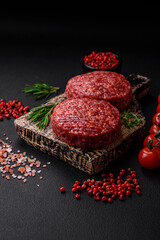 Fresh raw ground beef burger patty with salt and spices