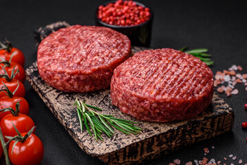 Fresh raw ground beef burger patty with salt and spices