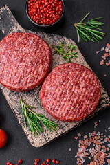 Fresh raw ground beef burger patty with salt and spices