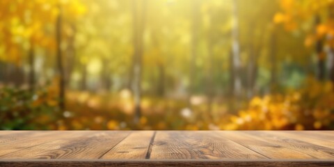 The empty rustic wooden table for product display with blur background of autumn forest. Exuberant image.