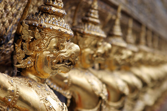 A row of gargoyles outside the shrine of the Emerald Buddha in Wat Po, Bangkok, Thailand.