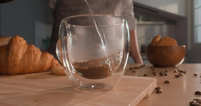 Instant coffee. Boiling water is poured into a cup with instant coffee. Closeup shot