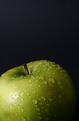 Green apple on black background